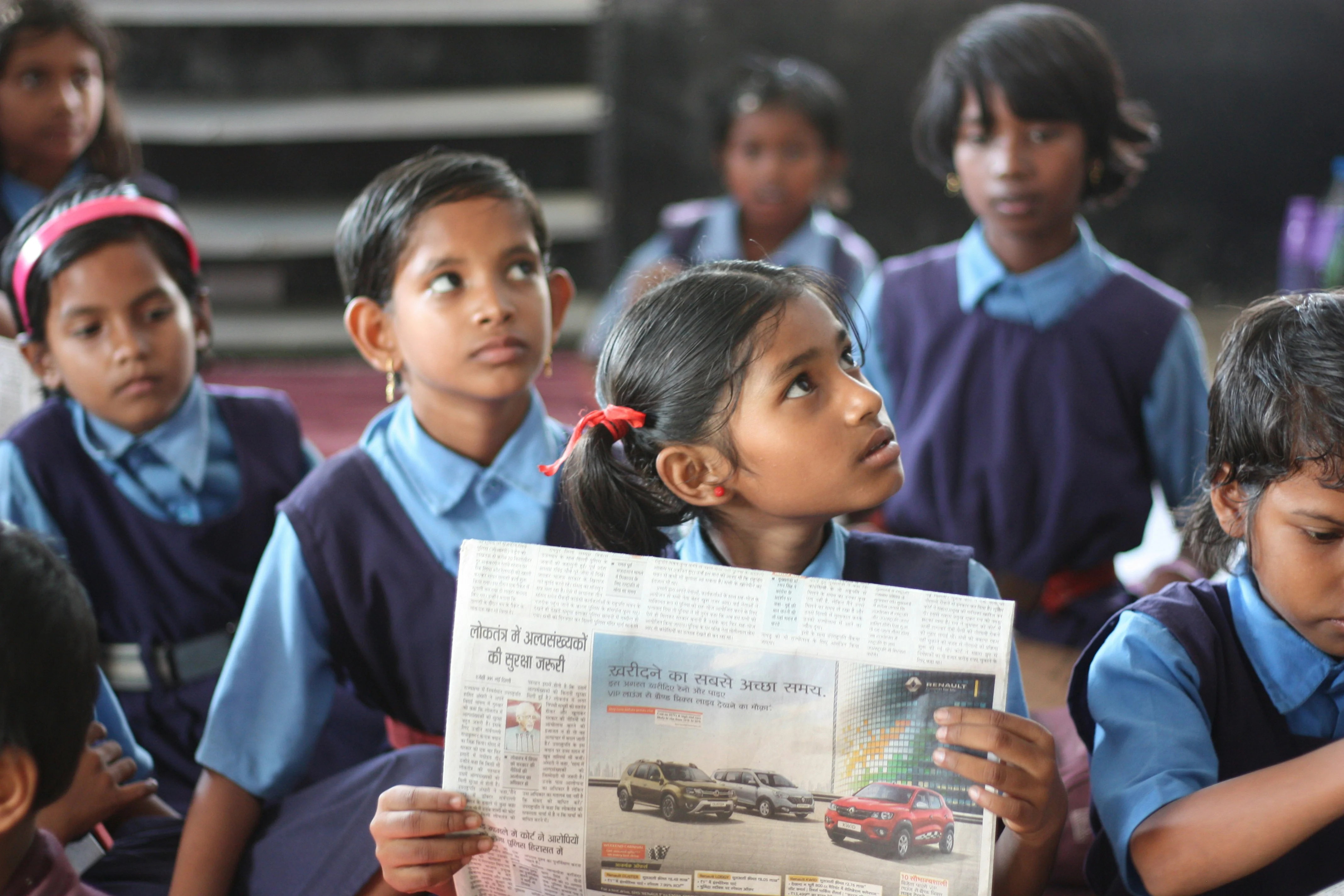 Children seated in a bright classroom, engaged in learning